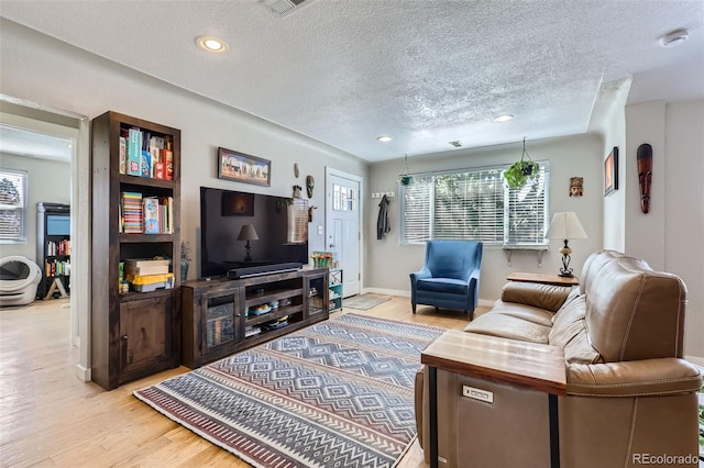 2901 N Glencoe St, Denver, CO 80207 - living area featuring a textured ceiling, light wood-type flooring, recessed lighting, and baseboards