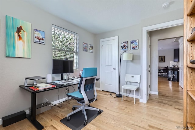 2901 N Glencoe St, Denver, CO 80207 - home office featuring light wood-type flooring and baseboards