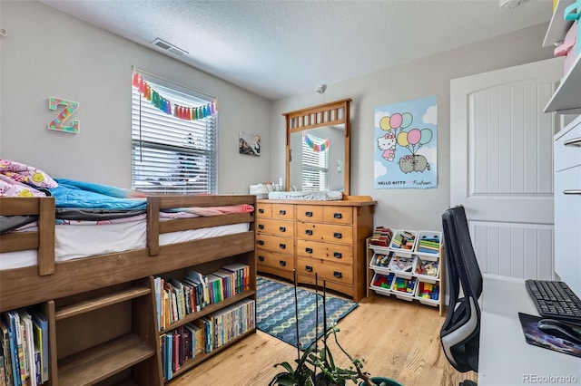 2901 N Glencoe St, Denver, CO 80207 - bedroom featuring wood finished floors and a textured ceiling