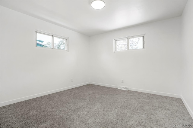 carpeted empty room with a healthy amount of sunlight