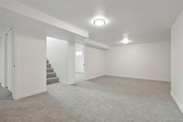 basement featuring light colored carpet