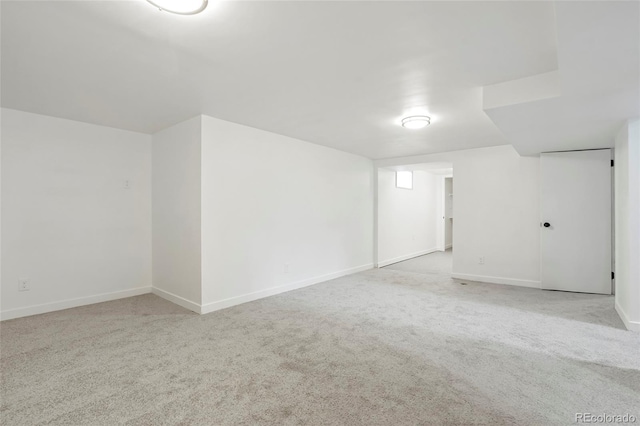 unfurnished room featuring light carpet