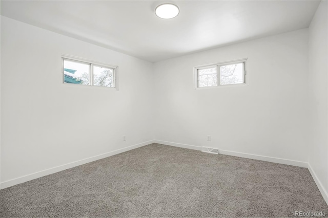 carpeted empty room with a wealth of natural light