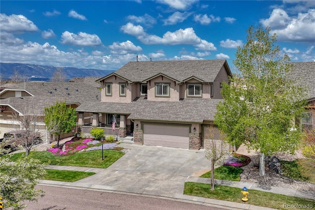 9952 Pinedale Dr, Colorado Springs, CO 80920 - view of front of home with a porch, stucco siding, stone siding, a garage, and concrete driveway