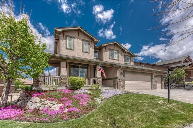 9952 Pinedale Dr, Colorado Springs, CO 80920 - view of front of home featuring a porch, stone siding, stucco siding, and driveway