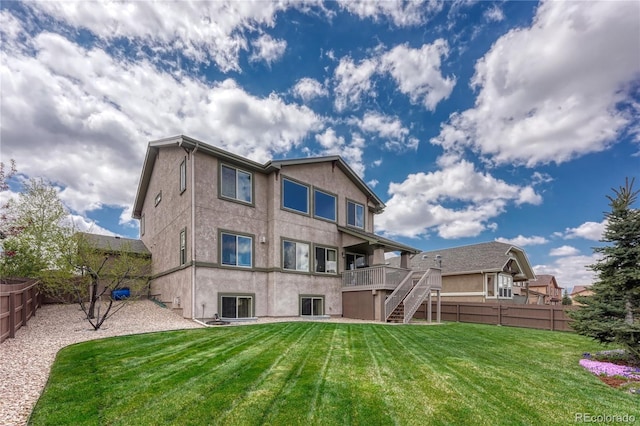 9952 Pinedale Dr, Colorado Springs, CO 80920 - back of property featuring stairway, a wooden deck, and stucco siding