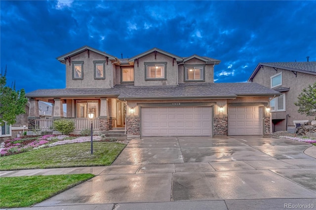 9952 Pinedale Dr, Colorado Springs, CO 80920 - view of front of home featuring stucco siding, driveway, a front yard, a garage, and a porch