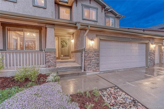 9952 Pinedale Dr, Colorado Springs, CO 80920 - view of front of property featuring stone siding, stucco siding, driveway, and a porch