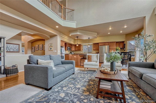 9952 Pinedale Dr, Colorado Springs, CO 80920 - living area featuring wood finished floors, recessed lighting, and a high ceiling