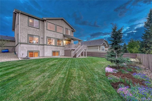 9952 Pinedale Dr, Colorado Springs, CO 80920 - back of property with stairway, a wooden deck, and stucco siding