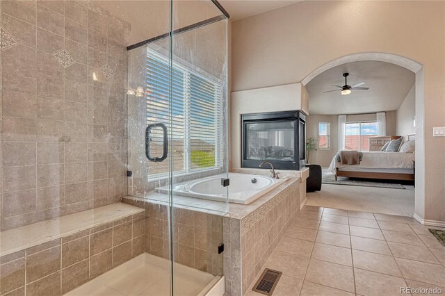 9952 Pinedale Dr, Colorado Springs, CO 80920 - ensuite bathroom featuring tile patterned floors, ceiling fan, a shower stall, a garden tub, and baseboards