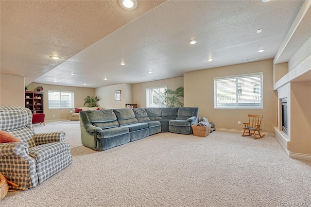9952 Pinedale Dr, Colorado Springs, CO 80920 - living area featuring carpet, baseboards, a textured ceiling, and recessed lighting