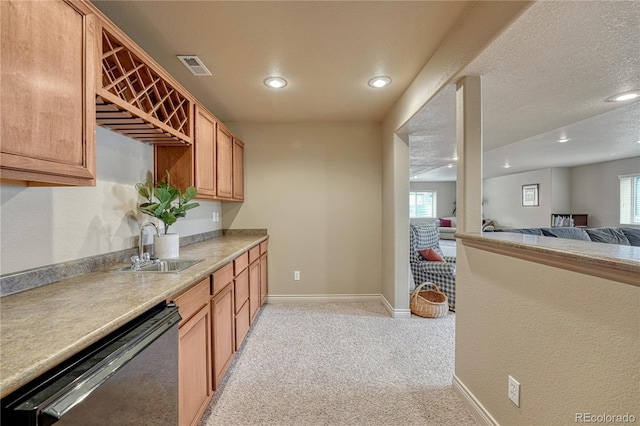 9952 Pinedale Dr, Colorado Springs, CO 80920 - kitchen featuring dishwashing machine, a sink, light carpet, open floor plan, and recessed lighting