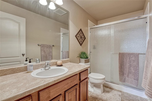 9952 Pinedale Dr, Colorado Springs, CO 80920 - bathroom with a shower stall, toilet, vanity, and tile patterned flooring