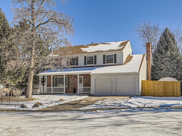 view of property with a garage and covered porch