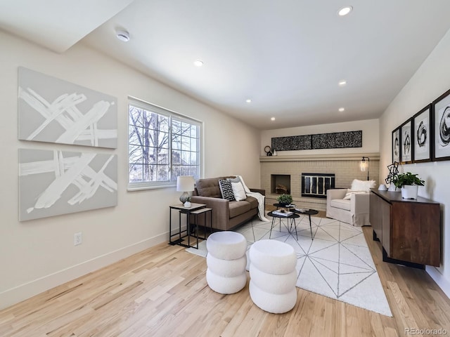 living room featuring a fireplace and light hardwood / wood-style flooring