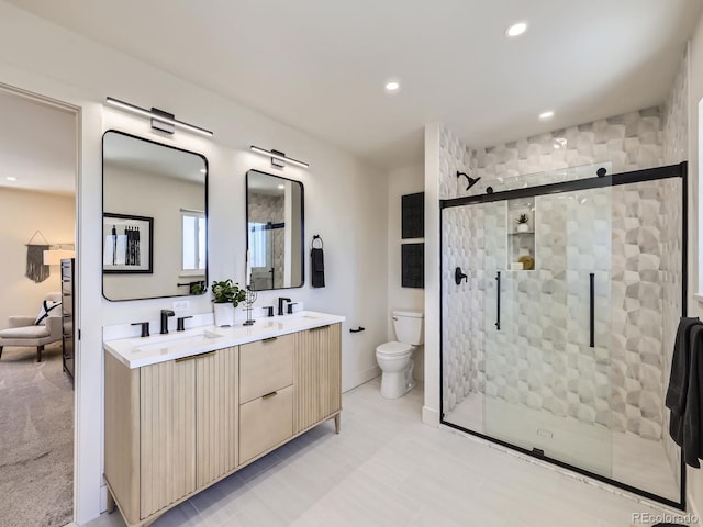 bathroom featuring vanity, toilet, and walk in shower