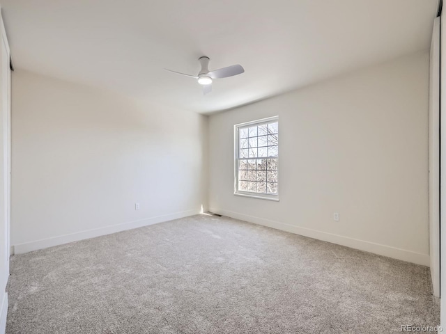 spare room with ceiling fan and carpet flooring