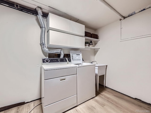 laundry area featuring washer and dryer and light wood-type flooring