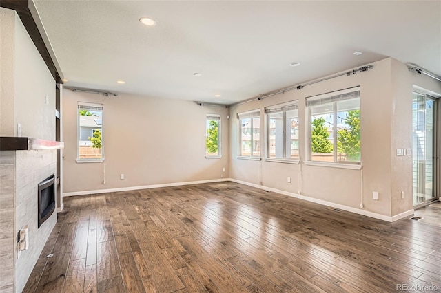15437 W 95th Ave, Arvada, CO 80007 - unfurnished living room featuring dark wood finished floors, recessed lighting, and a fireplace