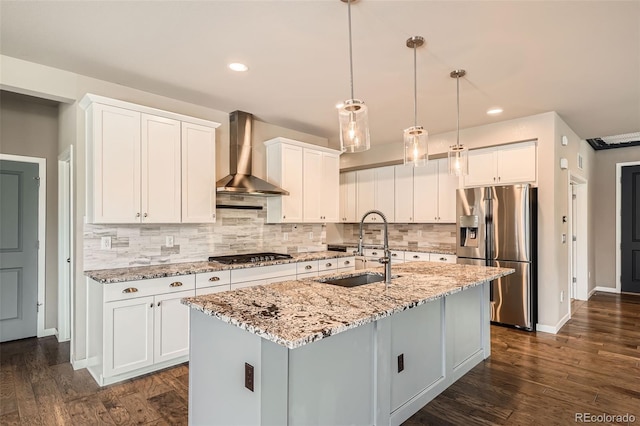 15437 W 95th Ave, Arvada, CO 80007 - kitchen with stainless steel refrigerator with ice dispenser, wall chimney exhaust hood, gas cooktop, tasteful backsplash, and white cabinetry