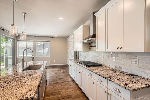 15437 W 95th Ave, Arvada, CO 80007 - kitchen with wall chimney exhaust hood, stainless steel gas stovetop, dark wood-type flooring, white cabinets, and recessed lighting