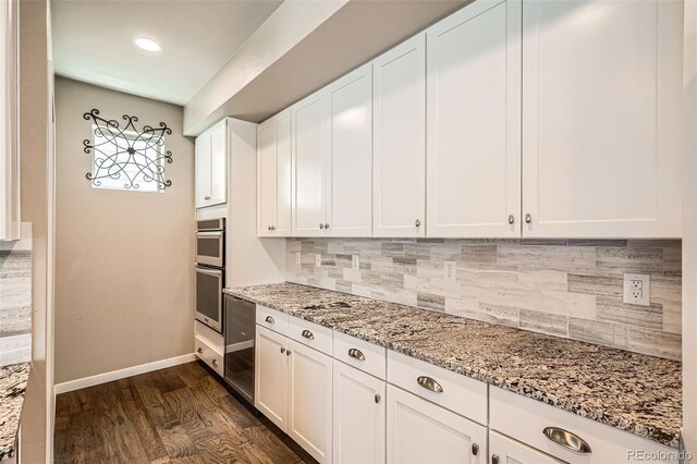 15437 W 95th Ave, Arvada, CO 80007 - kitchen featuring backsplash, light stone countertops, white cabinets, stainless steel double oven, and recessed lighting