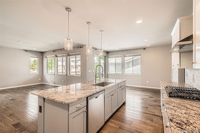 15437 W 95th Ave, Arvada, CO 80007 - kitchen featuring stainless steel appliances, wall chimney exhaust hood, dark wood-type flooring, open floor plan, and light stone counters