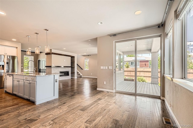 15437 W 95th Ave, Arvada, CO 80007 - kitchen featuring dark wood-type flooring, stainless steel appliances, light stone counters, recessed lighting, and pendant lighting