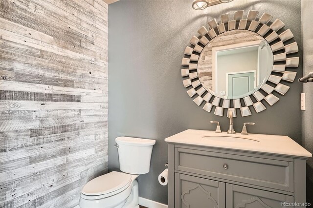 15437 W 95th Ave, Arvada, CO 80007 - bathroom featuring vanity and wooden walls