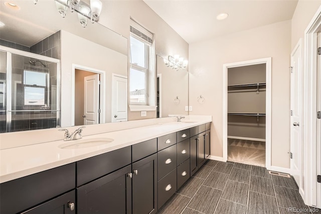 15437 W 95th Ave, Arvada, CO 80007 - full bath featuring double vanity, a stall shower, a walk in closet, and recessed lighting