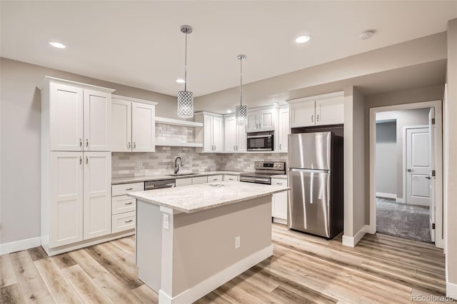 15437 W 95th Ave, Arvada, CO 80007 - kitchen featuring appliances with stainless steel finishes, light wood finished floors, white cabinetry, decorative backsplash, and recessed lighting