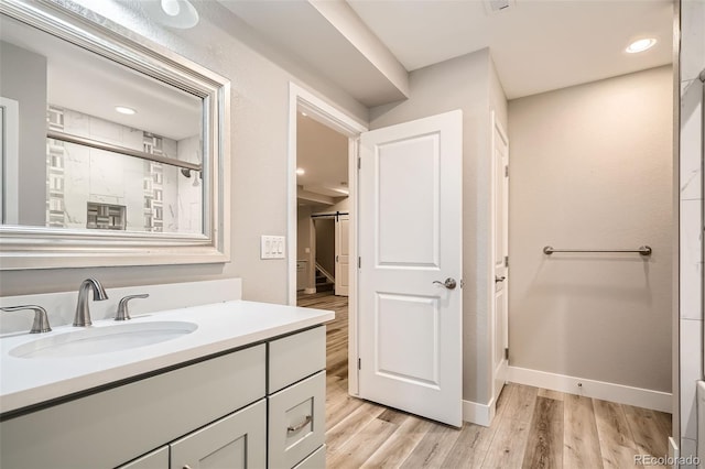 15437 W 95th Ave, Arvada, CO 80007 - full bathroom featuring wood finished floors, vanity, a shower, and recessed lighting