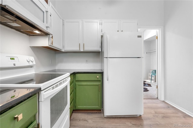 3050 W 107th Pl Unit E, Westminster, CO 80031 - kitchen featuring white appliances, range hood, white cabinets, light wood finished floors, and dark countertops