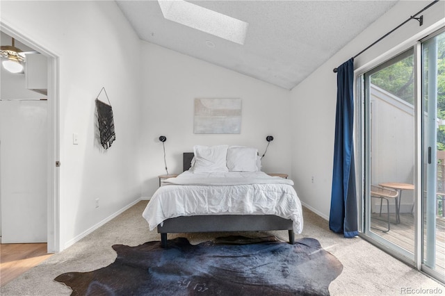 3050 W 107th Pl Unit E, Westminster, CO 80031 - bedroom with a skylight, access to exterior, lofted ceiling, carpet flooring, and baseboards