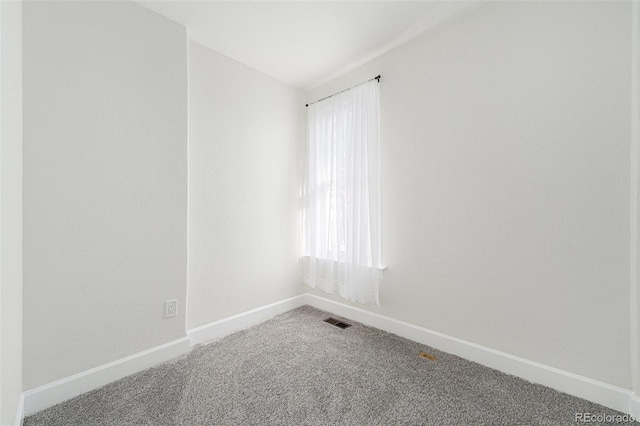 unfurnished room featuring carpet flooring and baseboards