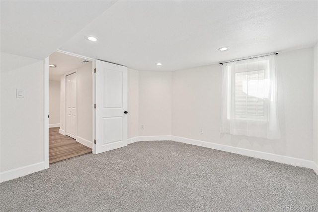 below grade area featuring carpet floors, baseboards, and recessed lighting