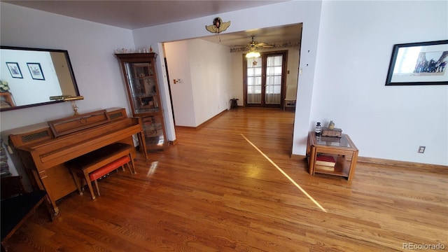 hall with wood finished floors and baseboards