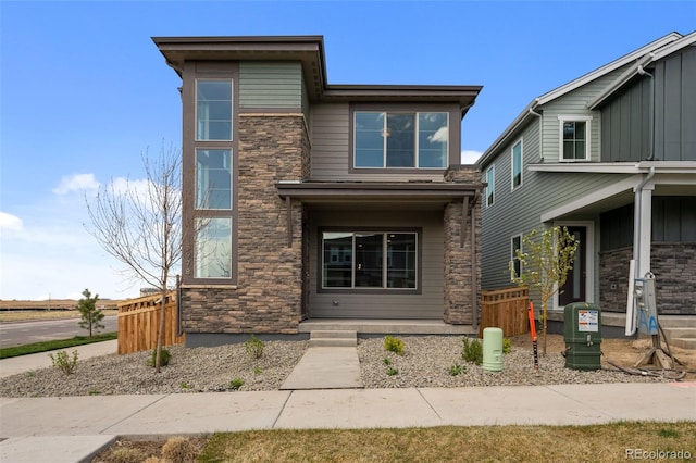 view of front facade featuring stone siding and a porch