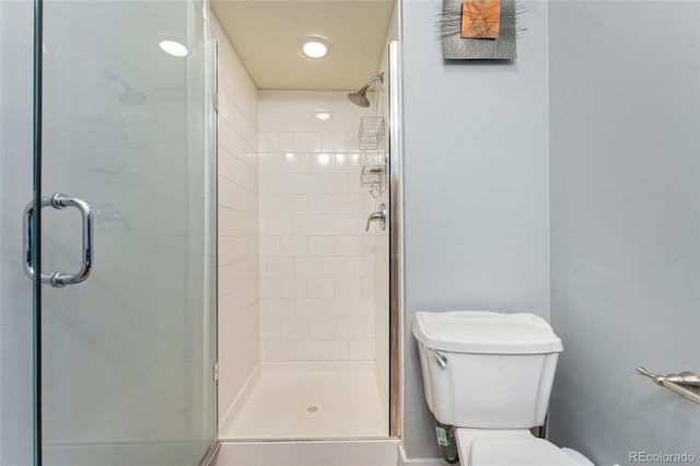 bathroom with a stall shower and toilet