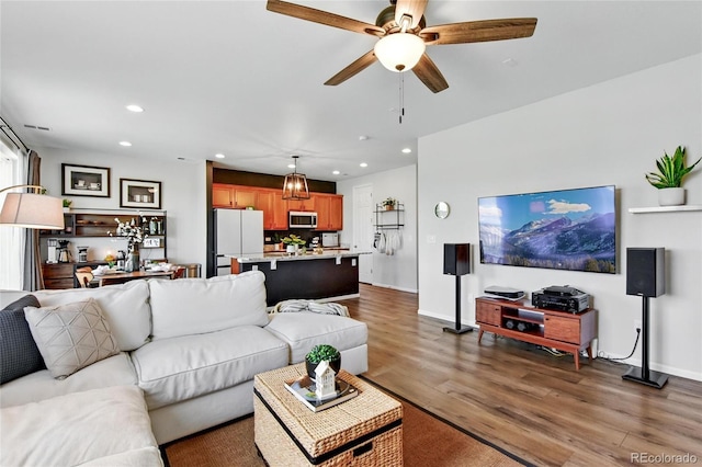 3699 Makley Cir, Castle Rock, CO 80104 - living area with wood finished floors, recessed lighting, a ceiling fan, and baseboards