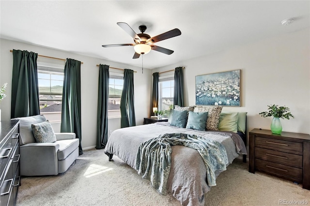 3699 Makley Cir, Castle Rock, CO 80104 - bedroom with multiple windows, light colored carpet, a ceiling fan, and baseboards
