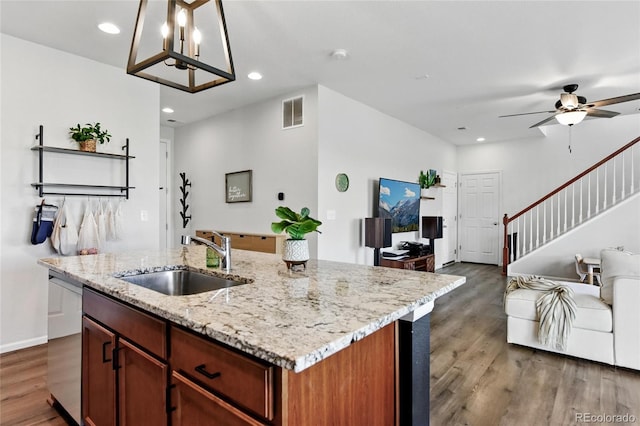 3699 Makley Cir, Castle Rock, CO 80104 - kitchen featuring a sink, wood finished floors, open floor plan, a ceiling fan, and an island with sink