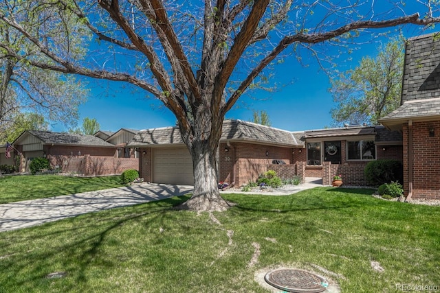 30 Eagle Dr, Littleton, CO 80123 - view of front of property with brick siding, an attached garage, driveway, and a front lawn