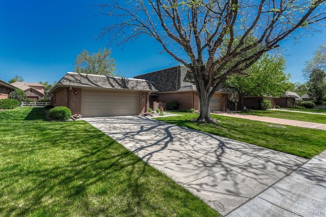 30 Eagle Dr, Littleton, CO 80123 - view of front facade featuring brick siding, mansard roof, driveway, a front lawn, and an attached garage