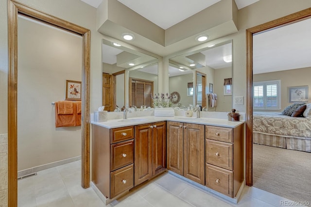 30 Eagle Dr, Littleton, CO 80123 - ensuite bathroom featuring double vanity, tile patterned floors, recessed lighting, and baseboards