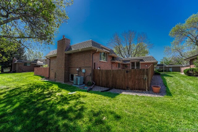 30 Eagle Dr, Littleton, CO 80123 - rear view of property featuring brick siding, a chimney, and cooling unit
