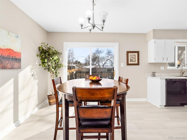 dining space featuring a notable chandelier and sink