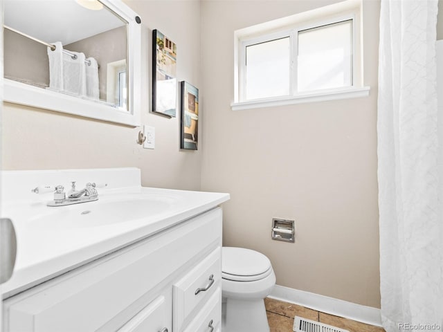 bathroom featuring vanity, toilet, and tile patterned flooring