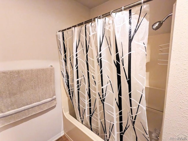 bathroom with shower / bath combo with shower curtain